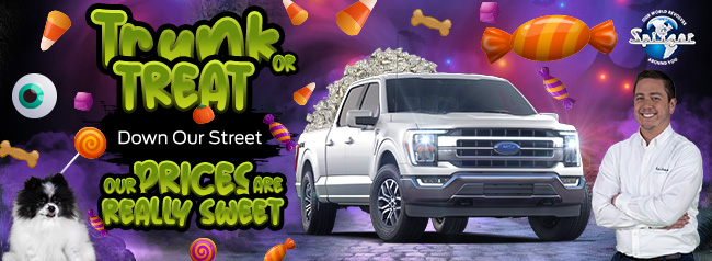 trunk or treat - our prices are really sweet with a white Ford truck in a Halloween scene