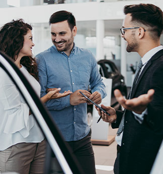 couple shopping at car showroom