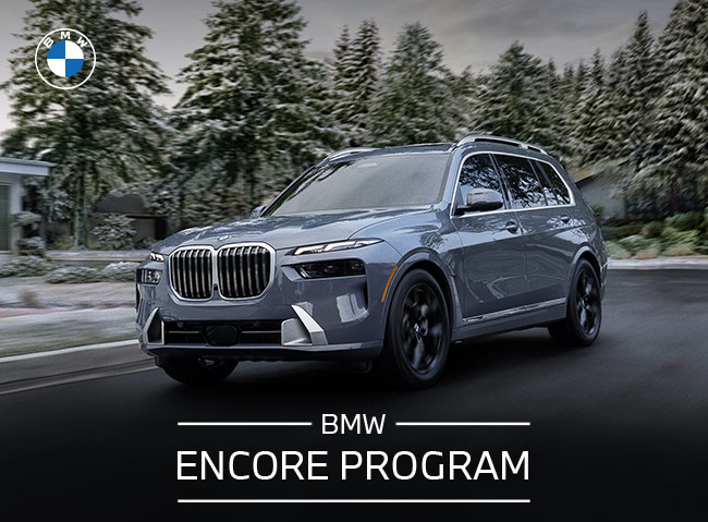 BMW Encore Program, with woman standing next to BMW