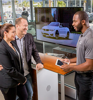 couple shopping at car showroom