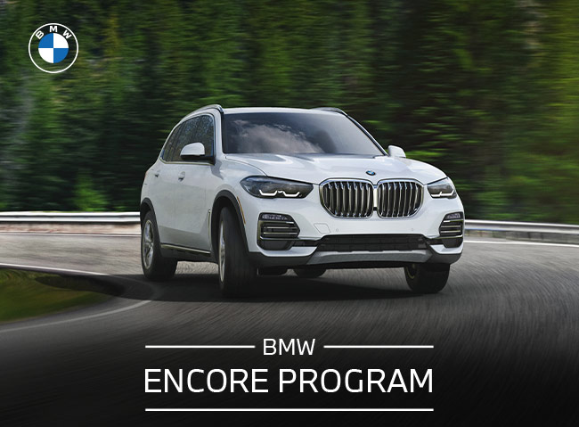 BMW Encore Program, with woman standing next to BMW