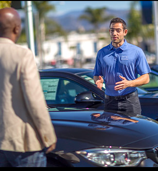 couple shopping at car showroom