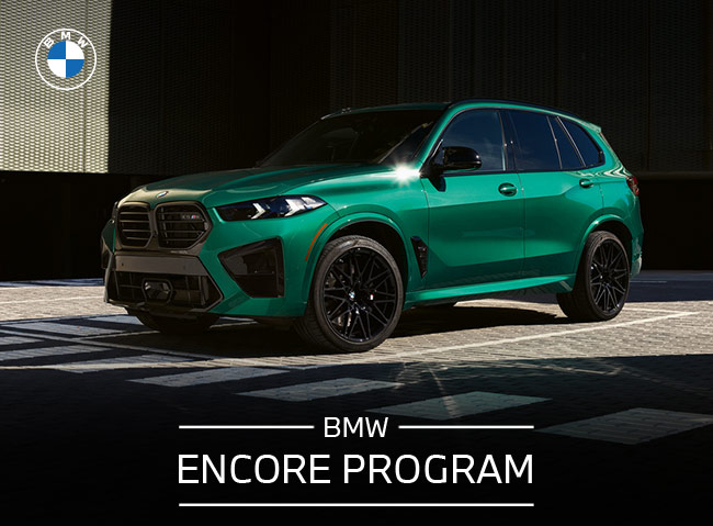 BMW Encore Program, with woman standing next to BMW