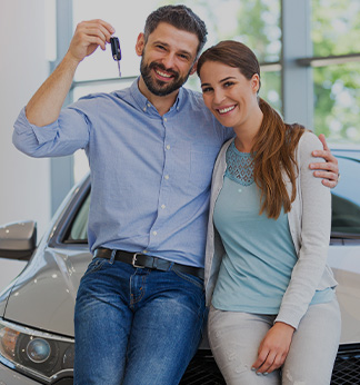 couple shopping at car showroom