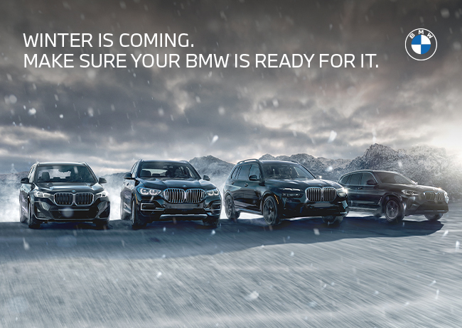 4 BMWs powering through a snow storm with new tires on