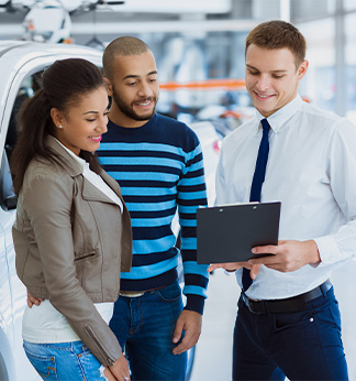 couple shopping at car showroom