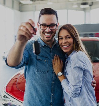 couple shopping at car showroom