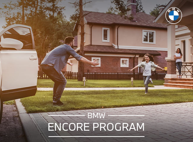 BMW Encore Program, with woman standing next to BMW