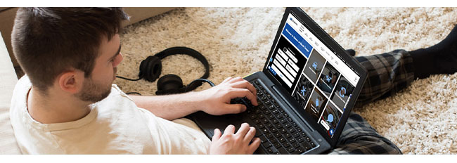 young man at home car shopping on the internet while wearing pajamas