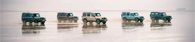 five INEOS GRENADIER models on wet beach