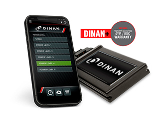 Gray BMW SUV driving though water on a beach