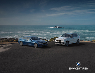 Two BMW Certified Models parked by the ocean