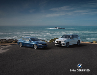 Two BMW Certified Models parked by the ocean