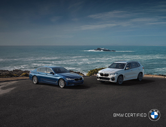 Two BMW Certified Models parked by the ocean