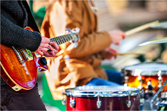 Picture of guitar player and drummer in a band