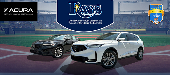 two new Acura models parked on a highway at night