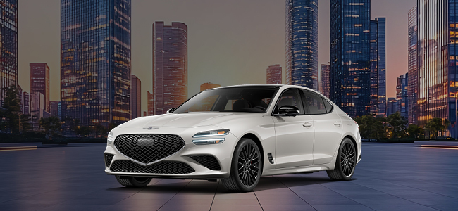 A gray Genesis G80 parked with water in the background