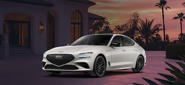 A gray Genesis G80 parked with a beach house in the background