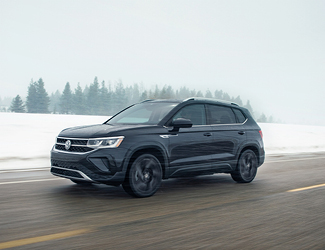 Black Volkswagen SUV drving in the snow