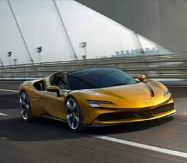 Yellow Ferrari driving on a road