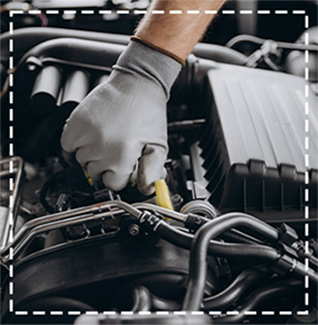 view of auto mechanics hand with wrench inside engine