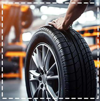 image of tire with hands on it in service bay